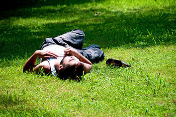Drunk man laying in the grass