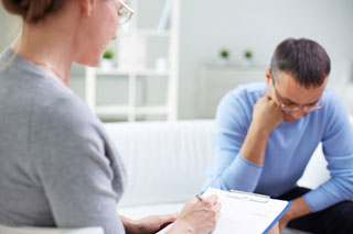 Man attending a therapy session with female therapist