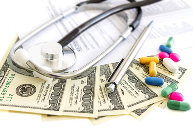 hundred dollar bills, pills, a pen, a document, and a stethoscope on top